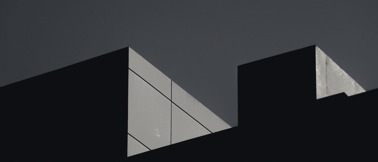 Detalle de arquitectura en penumbra, con un plano iluminado.